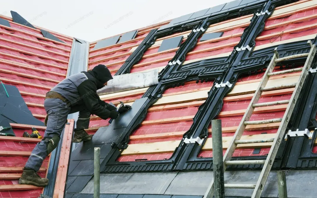 Roofer installing battens and underlayment on a new roof