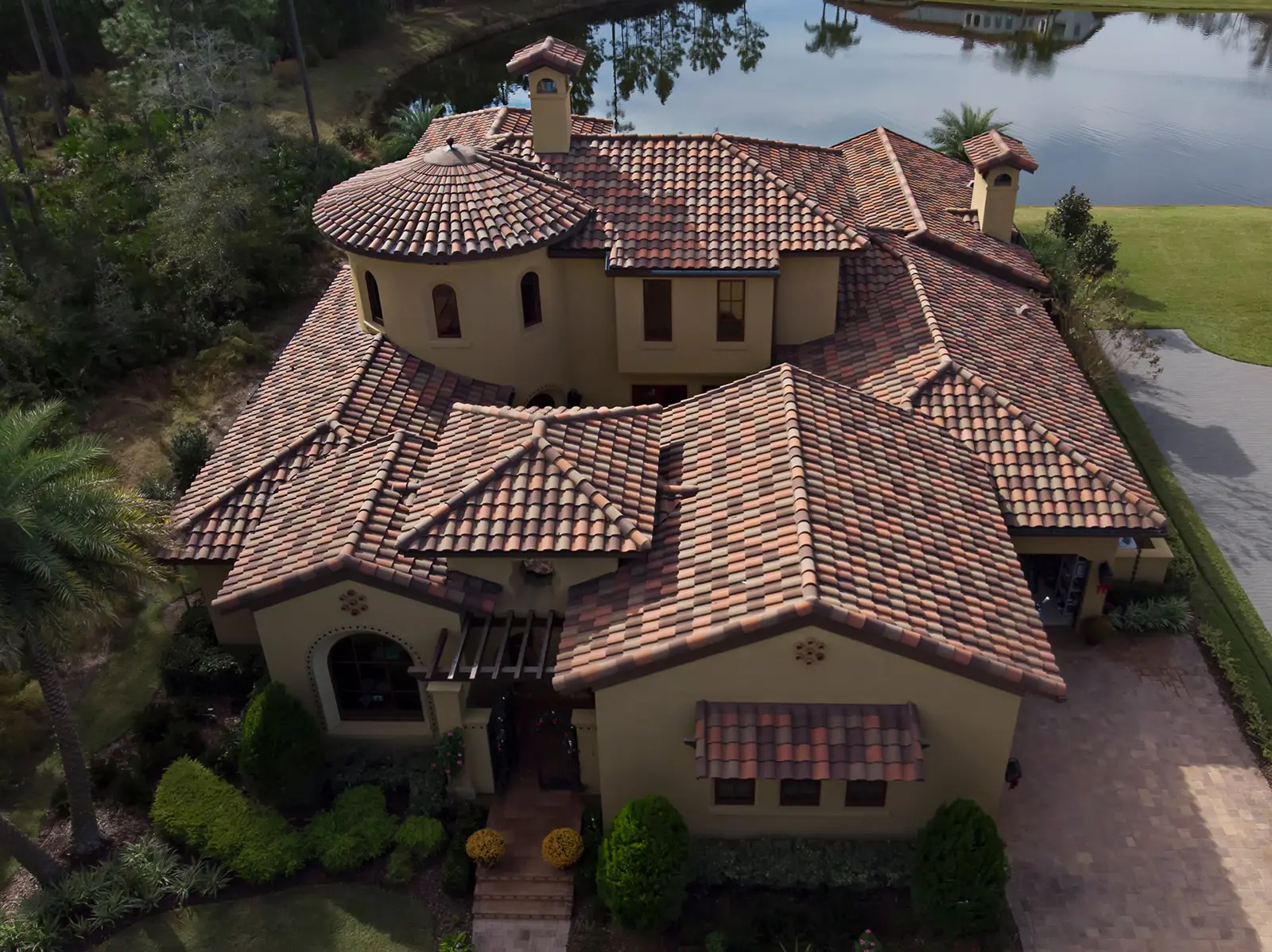 Aerial view of a new barrel tile roof installed by Cache Roofing on a Mediterranean-style waterfront home in the Jacksonville area