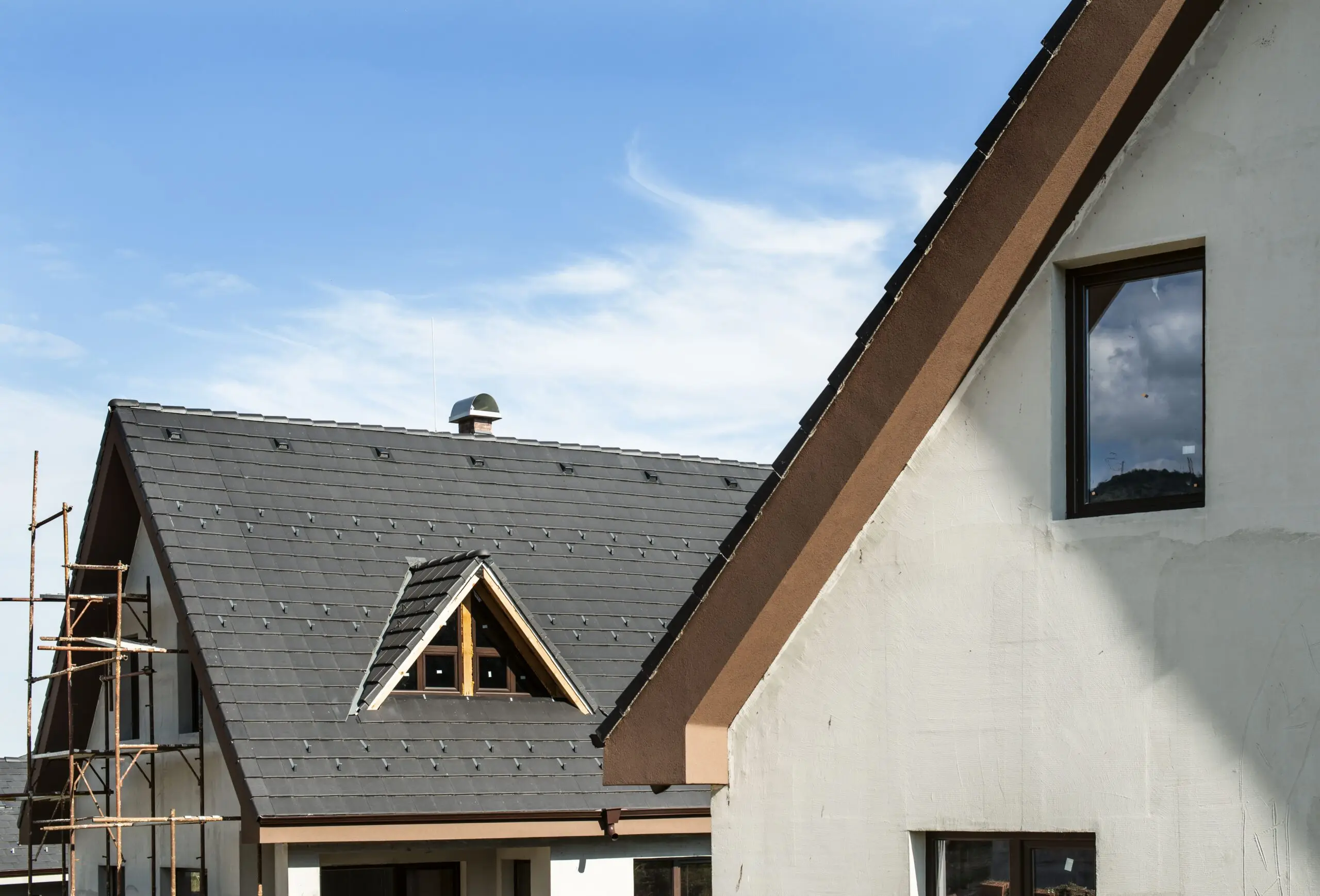 Roofer laying roof tiles on a pitched roof