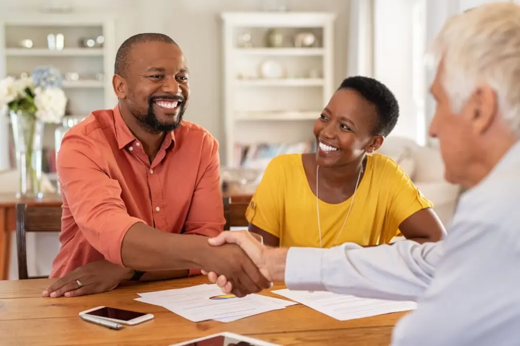 Homeowner shaking hands with an insurance agent