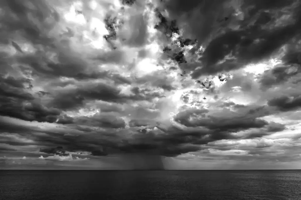 Dark storm clouds and rain over the ocean